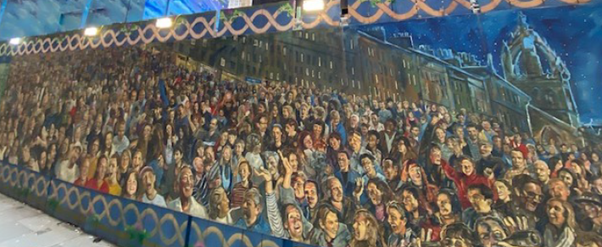 Mural on the construction hoardings during the North Bridge refurbishment. Depicts a crowd of happy people.